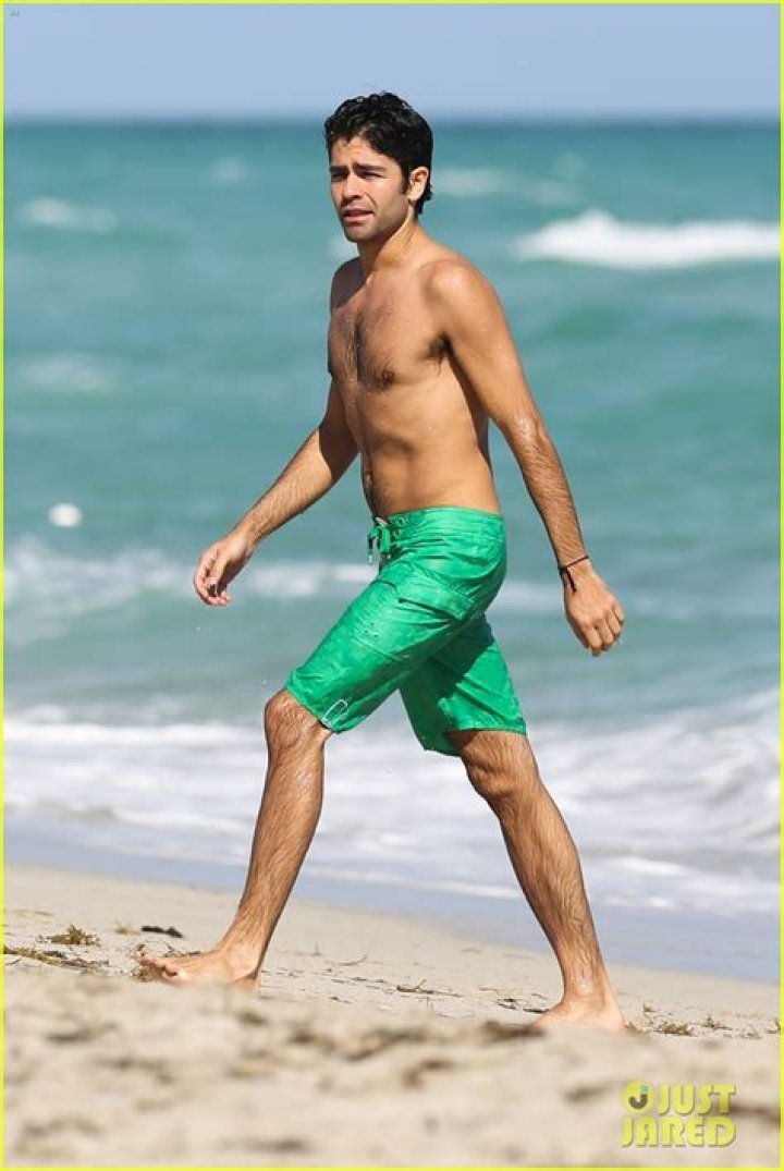 bitchy | Adrian Grenier goes a shirtless dip while on the beach with his girlfriend in Miami